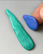Blue and green clay being molded